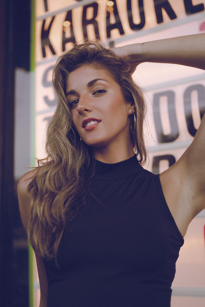 Fashionable woman posing confidently outdoors with a retro background.